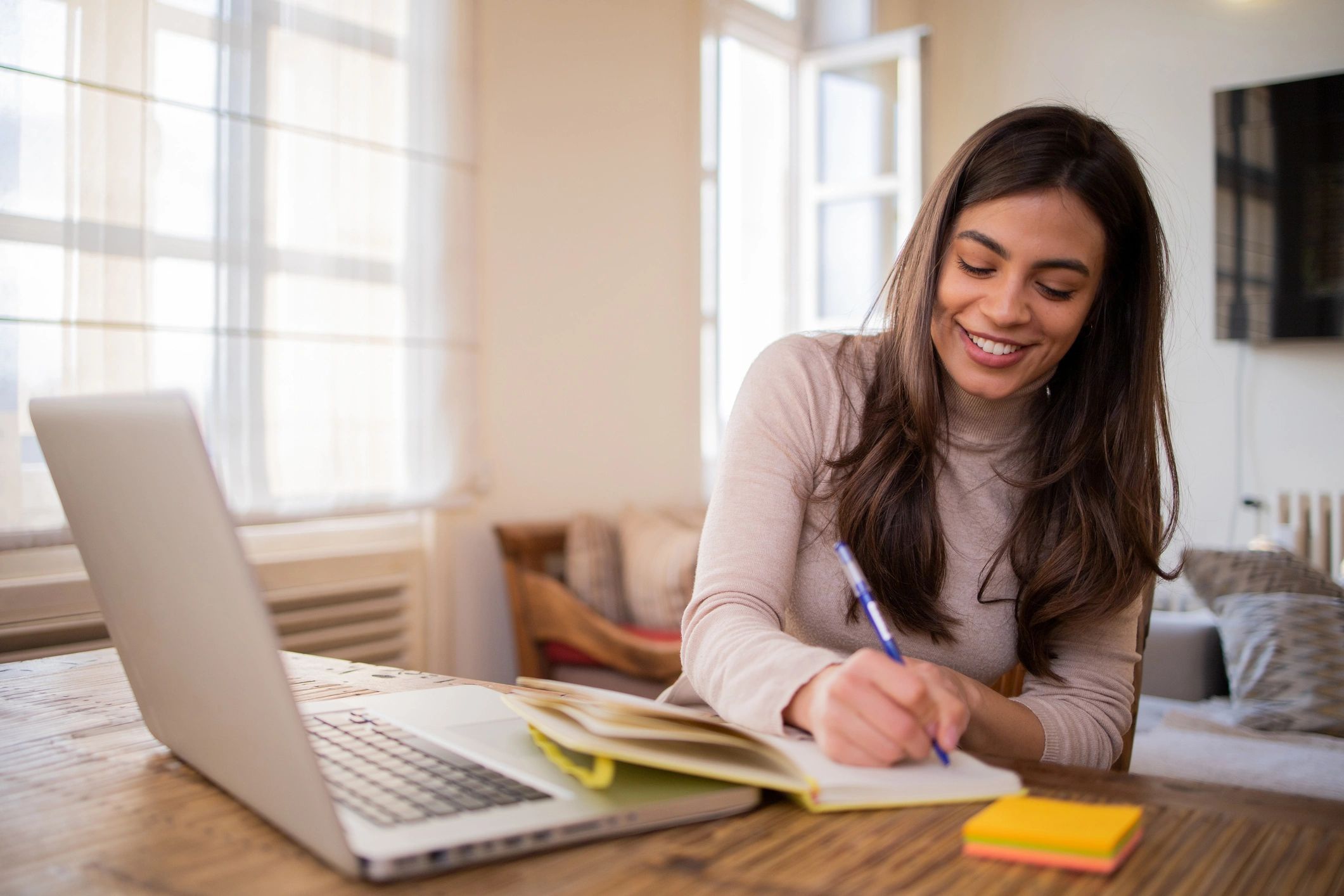 Woman working thoughtfully with a notebook