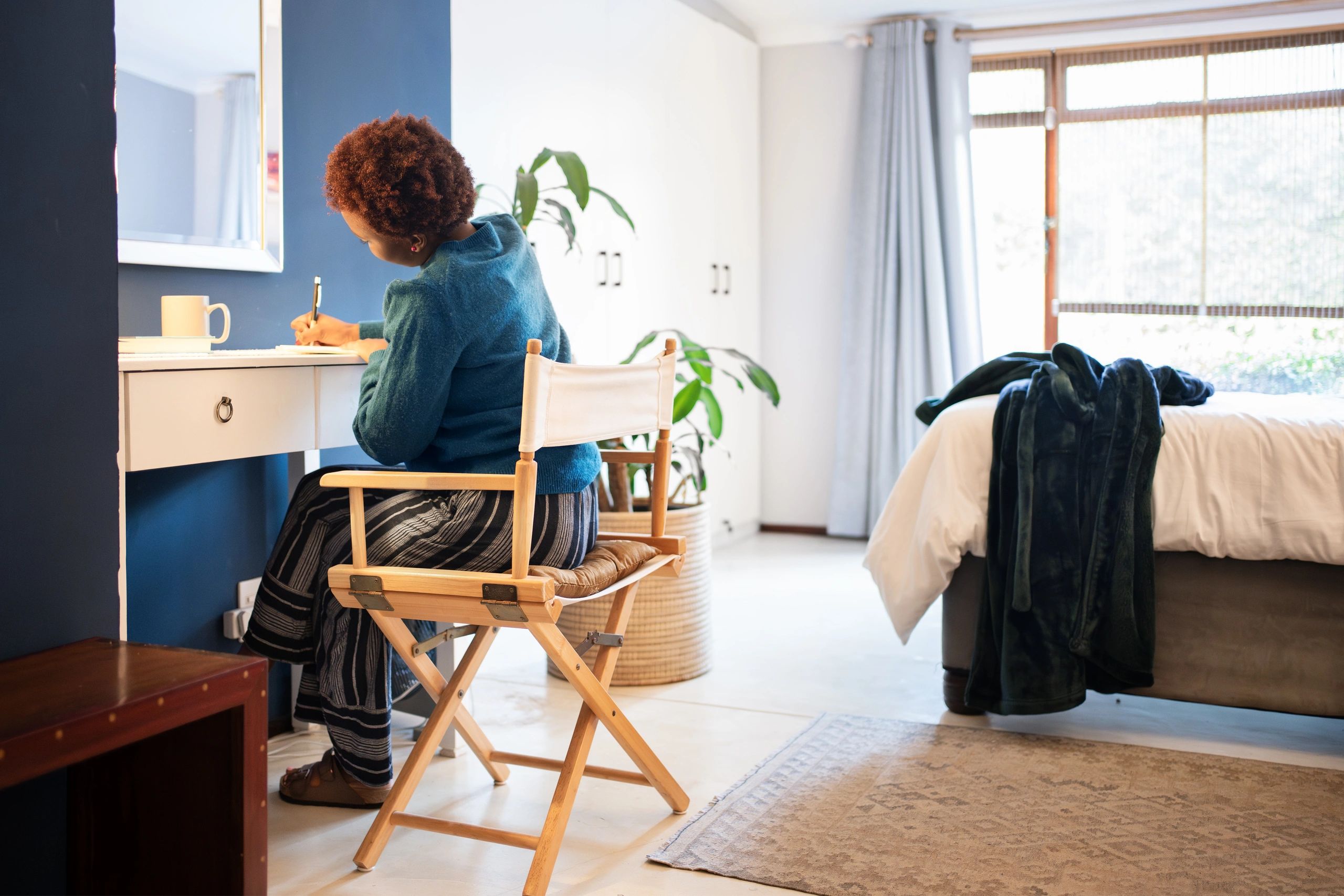 Young woman writing in a diary at home